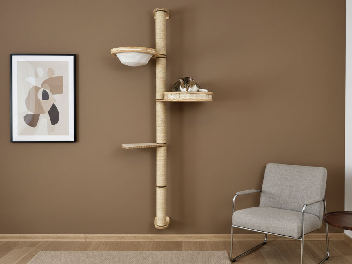 Cat tree with shelves on a brown wall next to a chair and abstract art