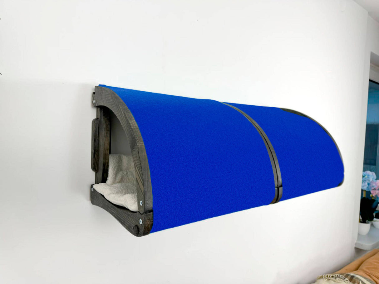 Blue pet bed attached to a white wall