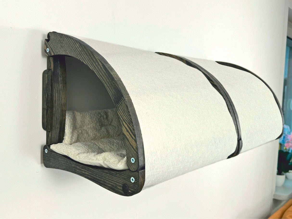 Wall-mounted pet bed with cushion on a white background