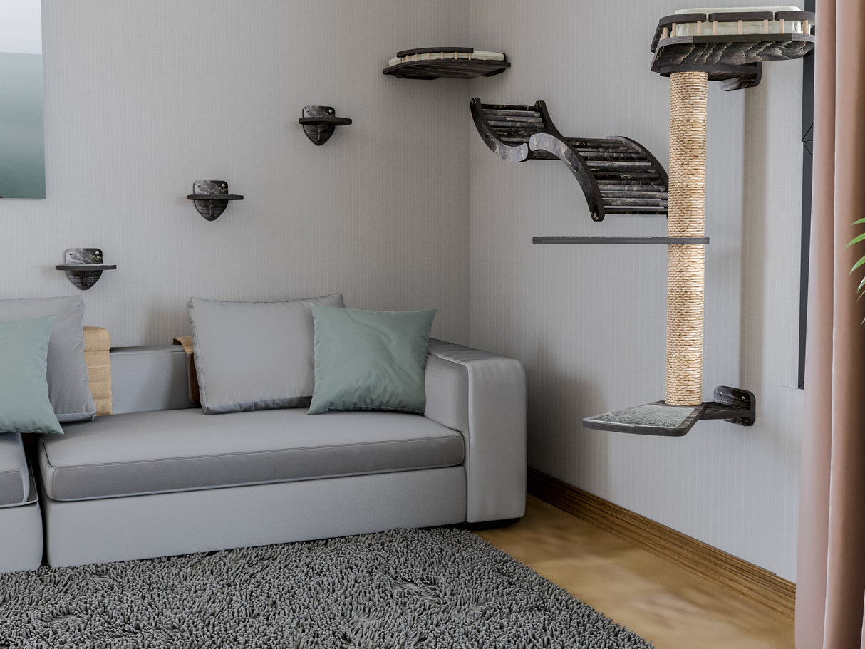 Living room with a gray sofa, cat tree, and shelves on a white wall.