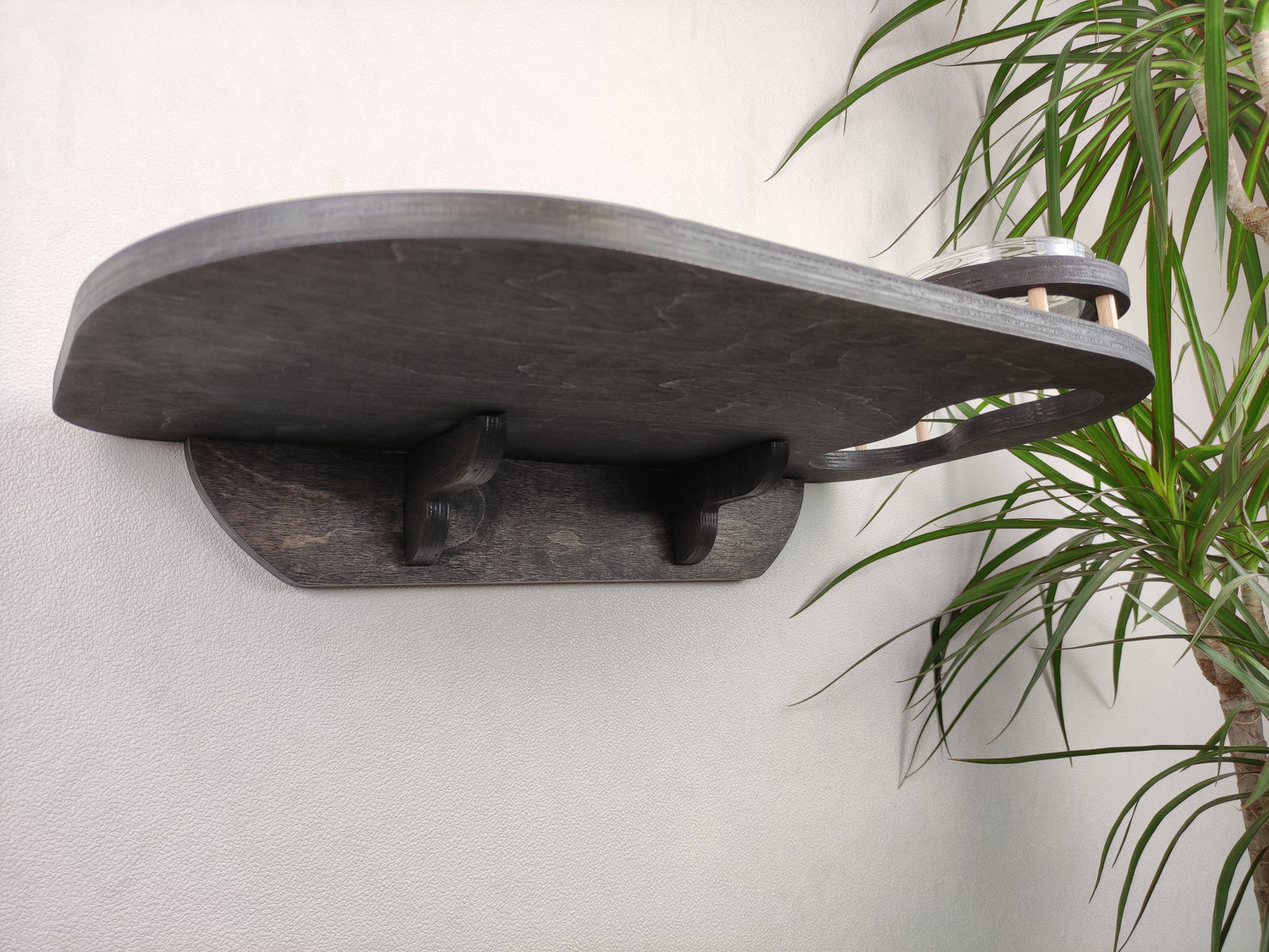 Elegant dark wood cat feeding station equipped with two glass bowls and a gray carpet for grip and convenience