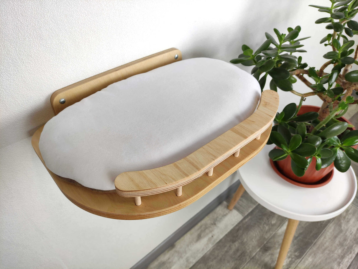 Cat Wall Bed a plant in the background