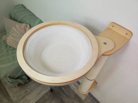 Wall tower for a cat in a round basket for resting the cat