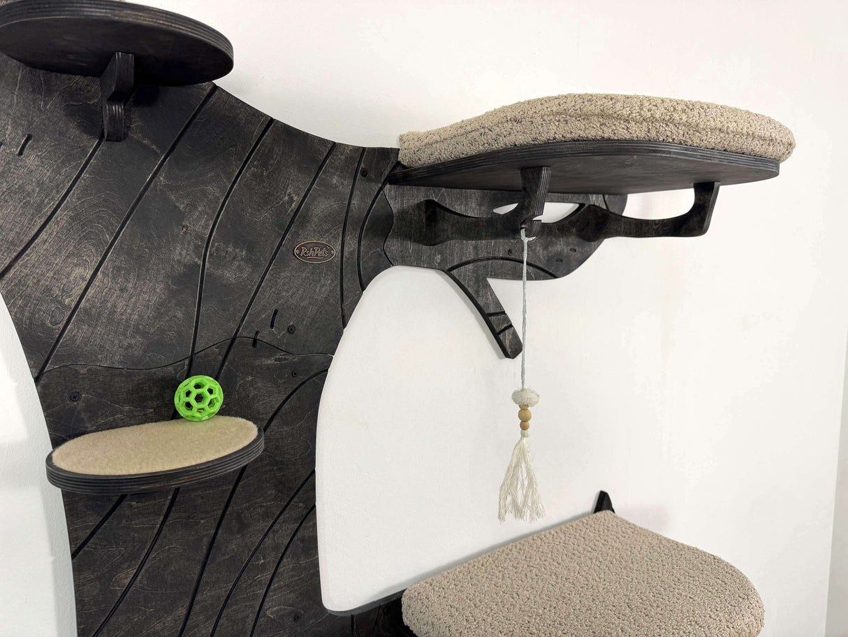 Cat tree with multiple platforms and a hanging toy on a white background