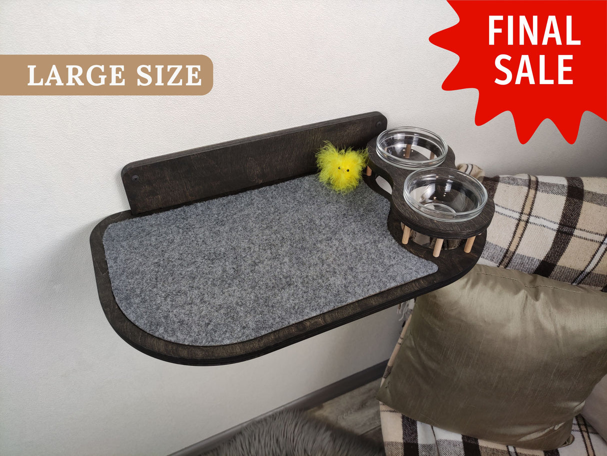 Wall-mounted dark wood feeding station featuring glass bowls and a soft gray carpeted surface for large cat breeds