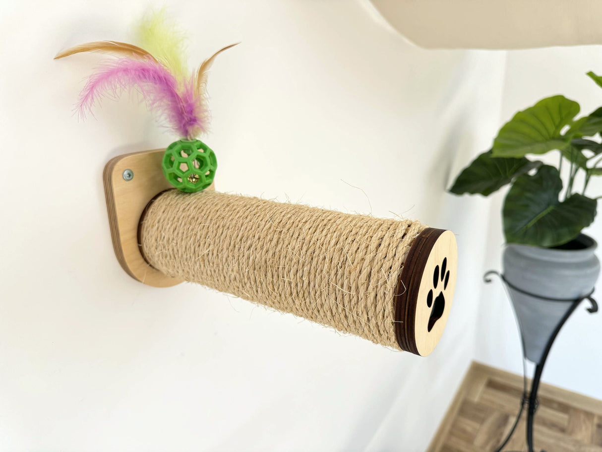 Cat scratch post with feather toy attached to a white wall