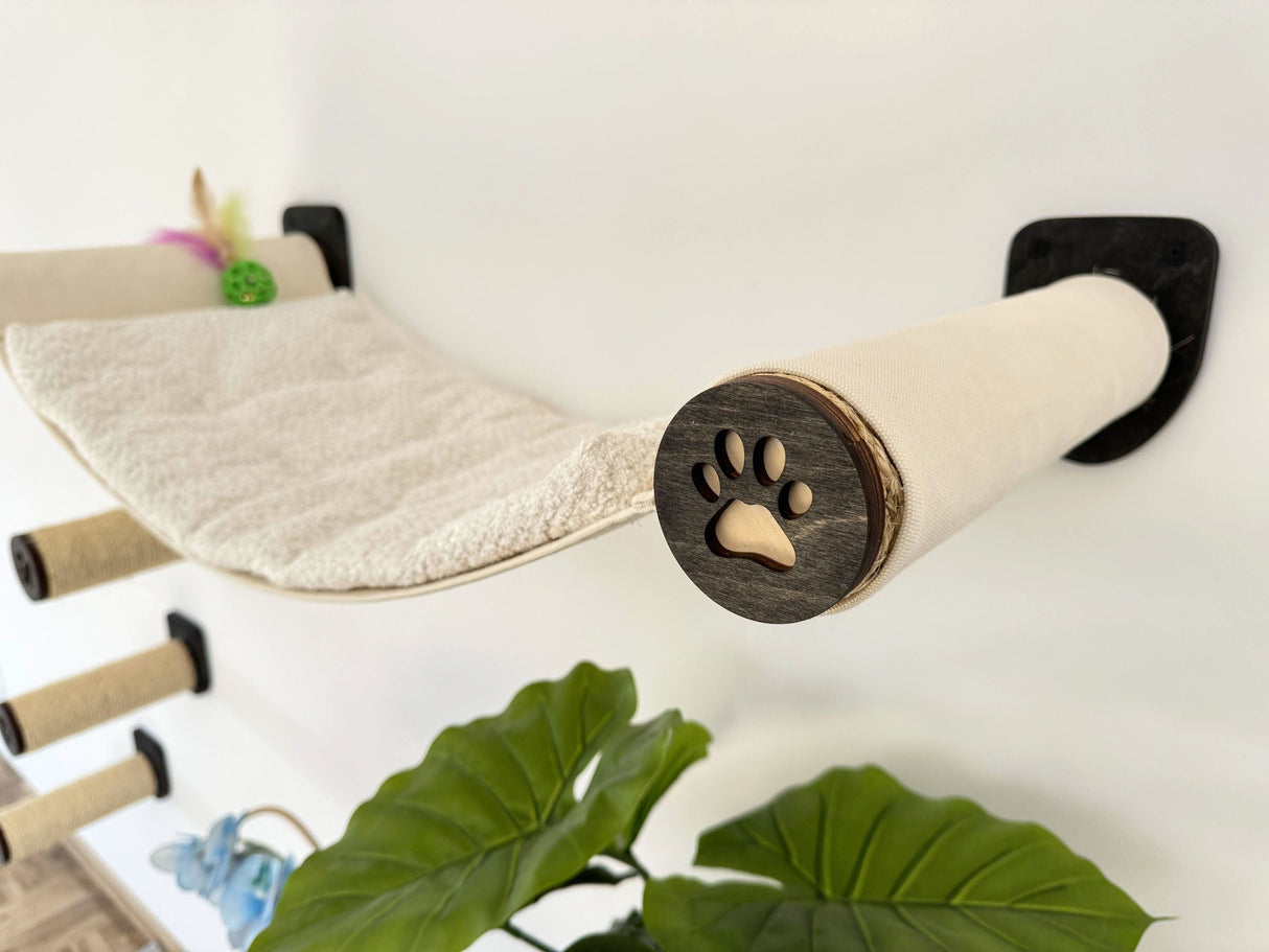 Cat climbing shelf with scratching posts and a paw print design on a light background