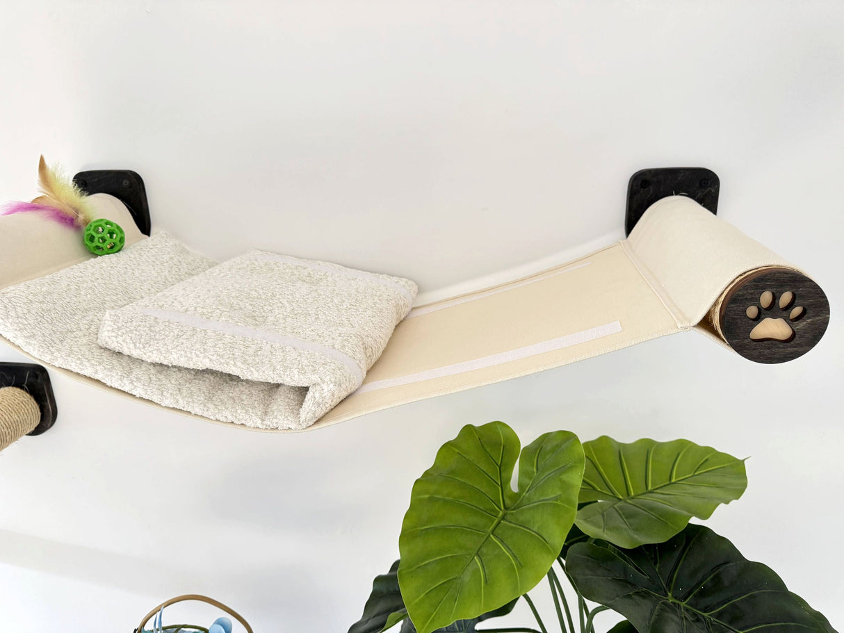 Cat hammock with a cushion and paw print design on a white background