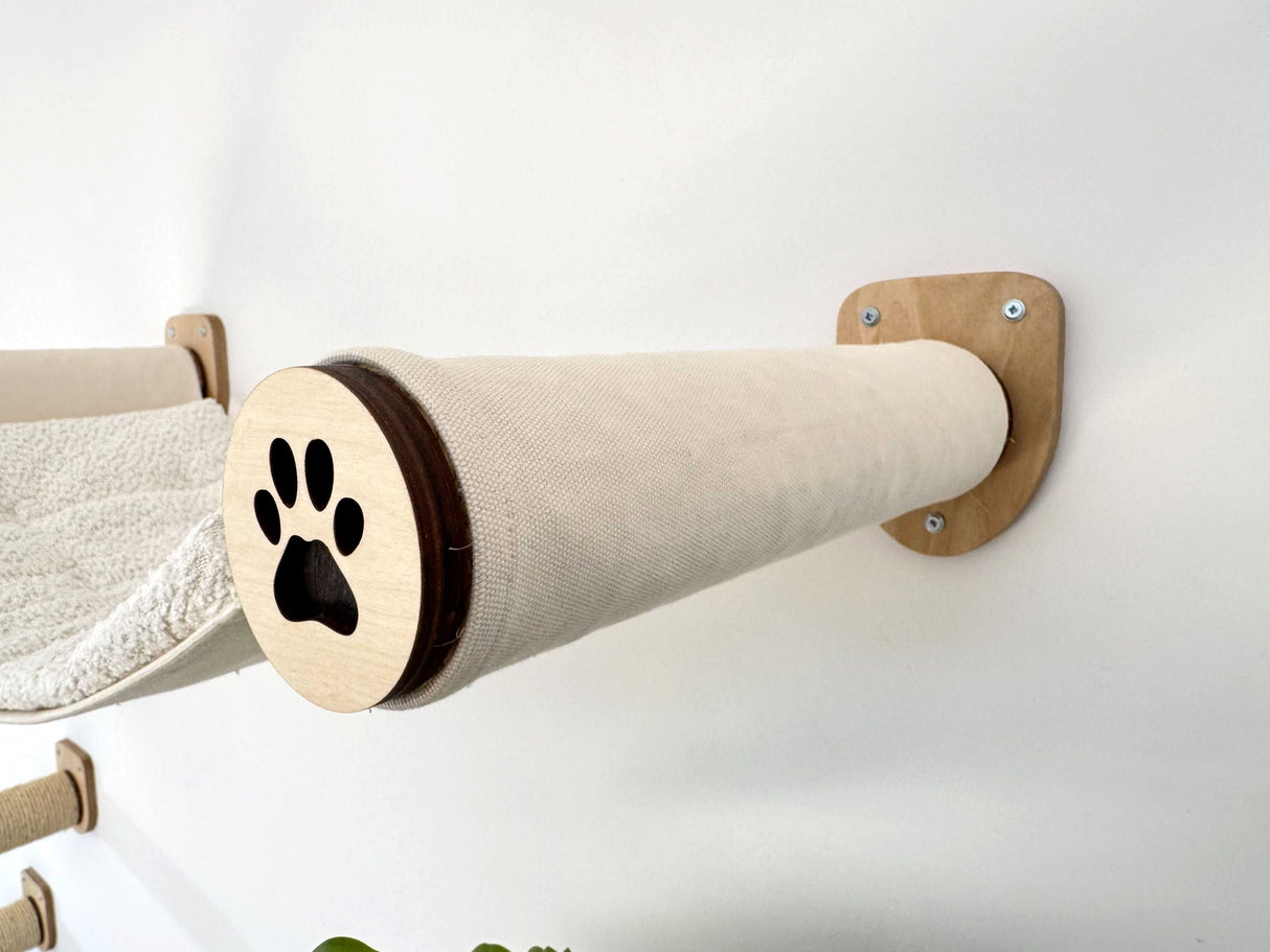 Cat climbing post with paw design on a white background