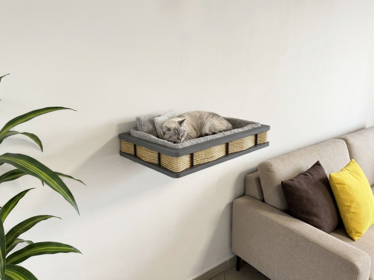 Cat resting on a wall-mounted cat bed in a living room.