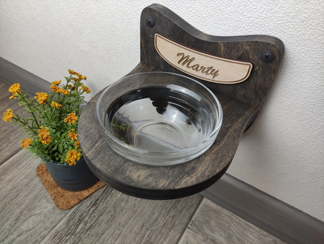 Modern cat feeder made of dark birch wood with a single glass bowl
