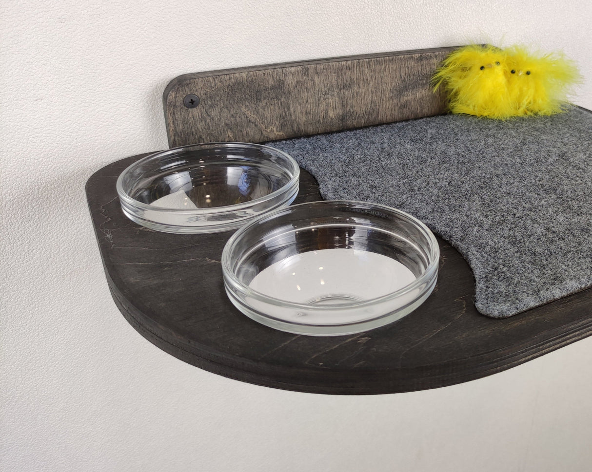 Elevated plywood cat feeder with felt mat and minimalist design