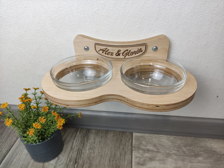 Minimalist cat feeding station with raised glass bowls, light color