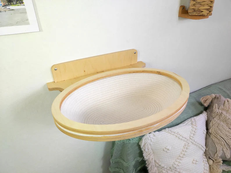 Wooden pet bed attached to a wall with a soft surface underneath