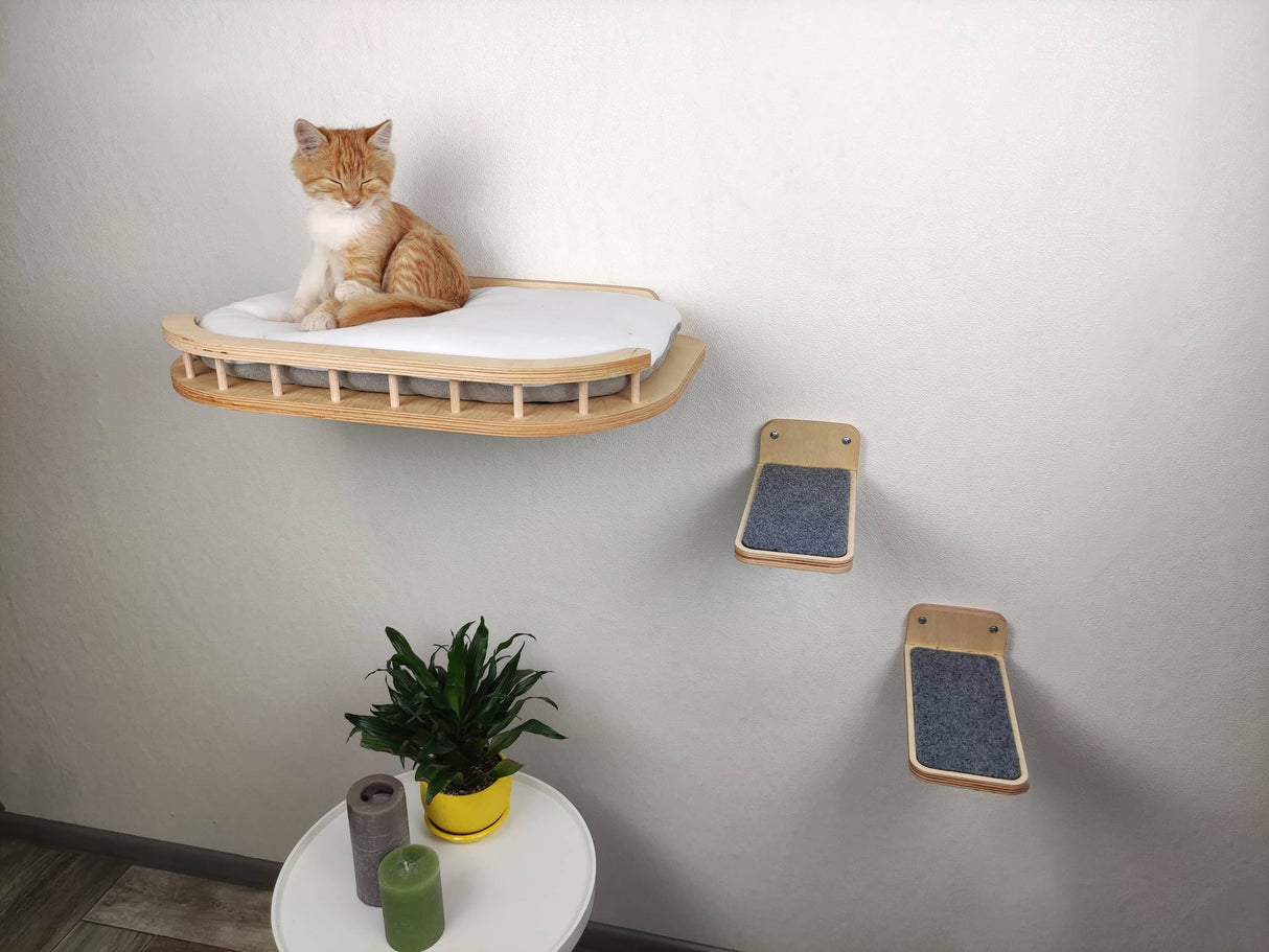 Light-colored wall-mounted cat bed with fluffy cushion