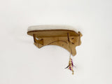 Wooden cat shelf with a decorative item on a white background