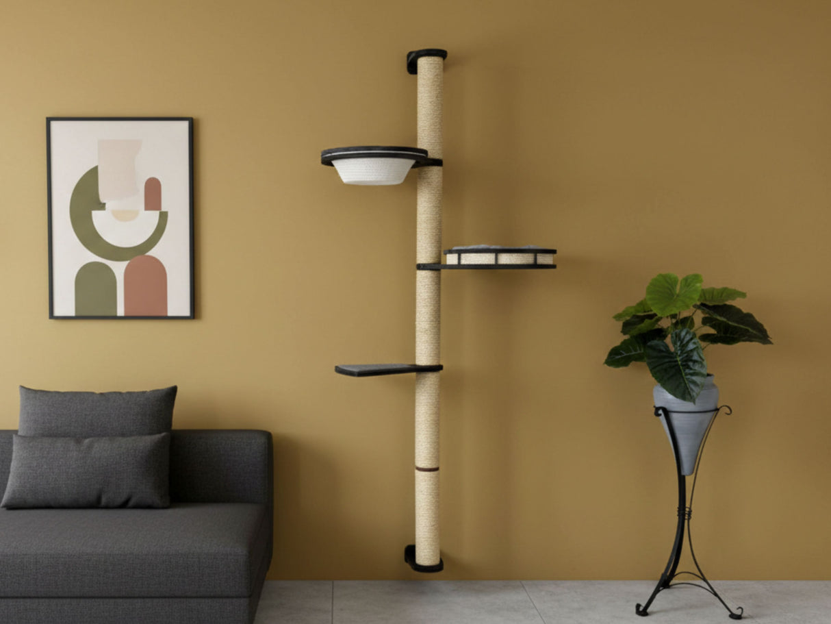 Cat tree against a wall with a couch and plant in the foreground