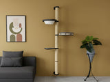 Cat tree against a wall with a couch and plant in the foreground