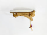 Wooden cat shelf with a cushion and feather toy on a white background