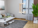 Modern living room with gray sofa, coffee table, and cat wall tree
