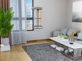 Modern living room with a cat tree, plants, and a city view.