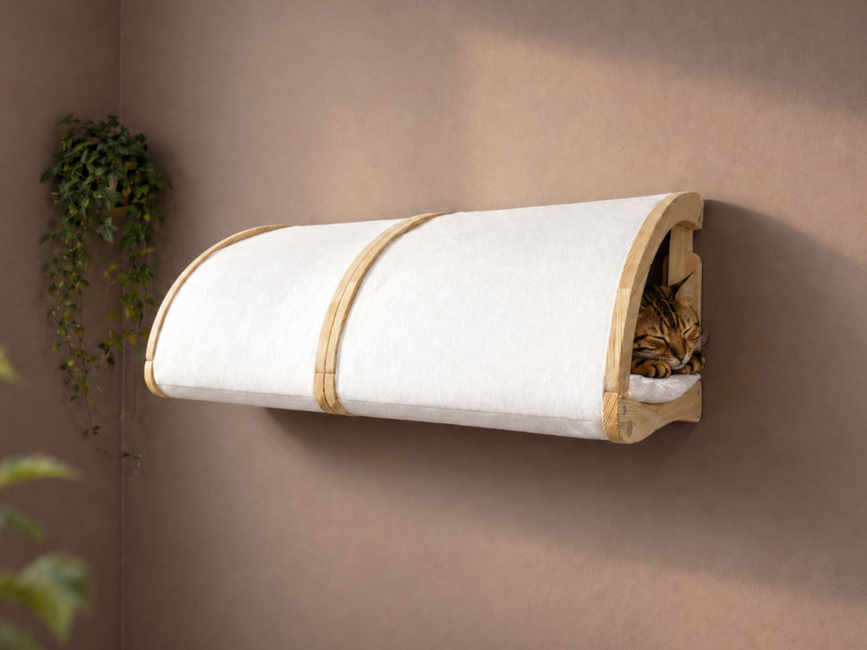 Wall-mounted cat bed with a cat inside on a beige wall.