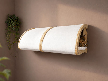 Wall-mounted cat bed with a cat inside on a beige wall.