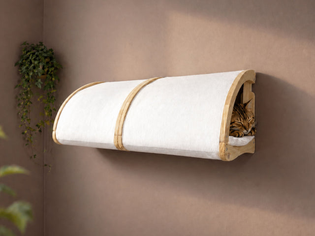 Wall-mounted cat bed with a cat inside on a beige wall.
