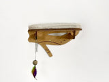 Wooden cat shelf with cushion and feather toy on a white background