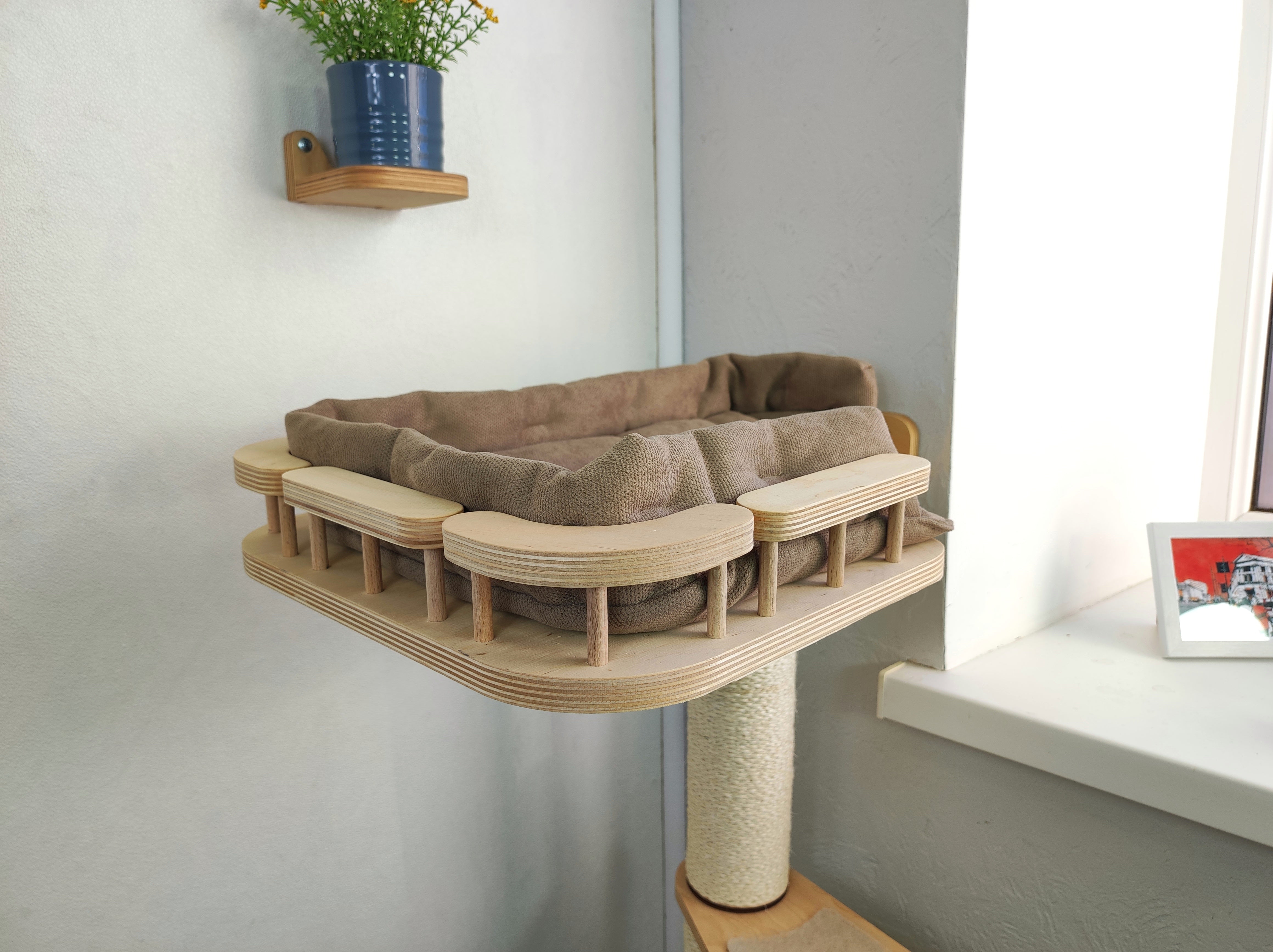Cat light shelf with soft cushion by the window is made of plywood