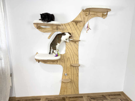 Wooden cat tree with two cats on a white background