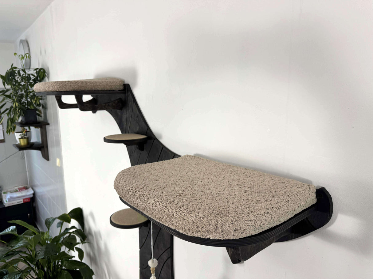 Wall-mounted cat tree with multiple platforms in a room setting