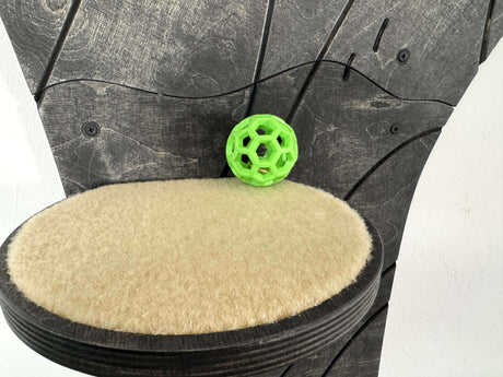 Green ball on a textured black and beige surface