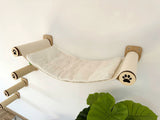 Cat hammock with sisal steps attached to a wall, featuring paw prints.