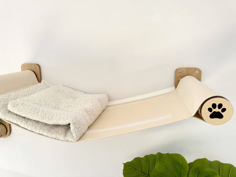 Cat climbing shelf with a paw print design on a white background
