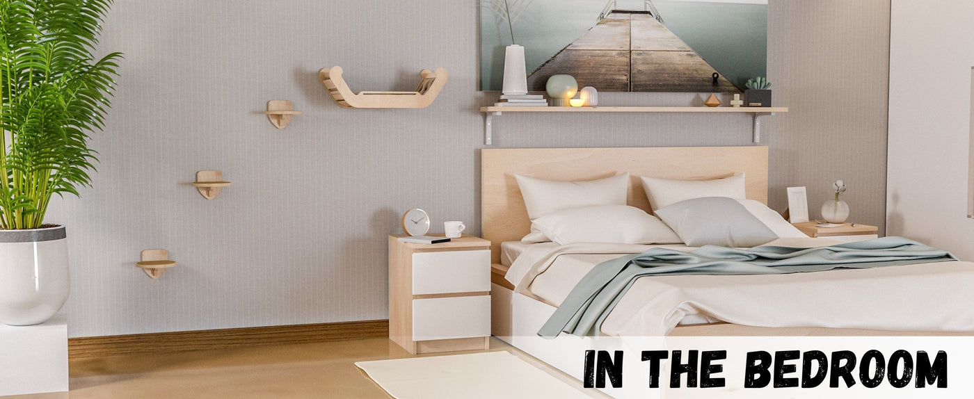 Modern bedroom with wooden furniture, plants, and cat furniture.