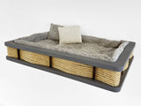 Pet bed with sisal-wrapped sides and plush cushion on a white background