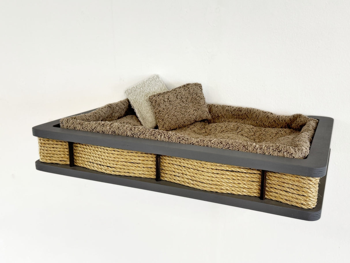 Pet bed with wicker sides and cushioned interior on a white background