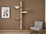 Cat tree with shelves on a brown wall next to a chair and abstract art