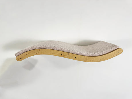 Wavy wooden cat shelf with cushion on a white background