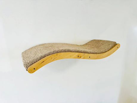 Curved wooden cat shelf with sisal-wrapped surface on a white background