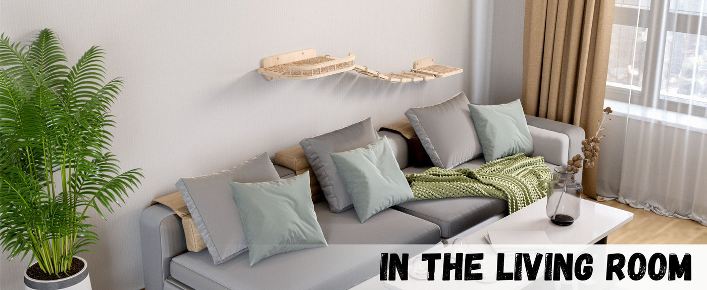 Living room with a gray sofa, green cushions, and a plant.
