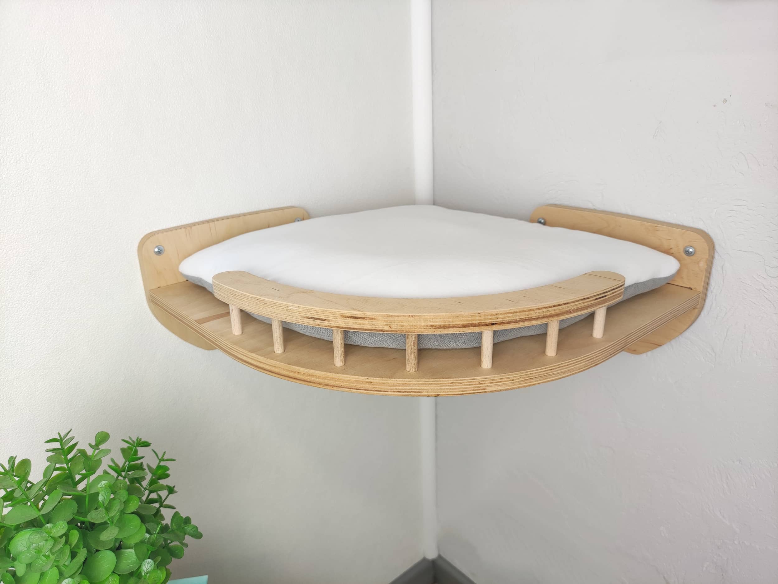 Wall-mounted corner cat shelf made of plywood with soft cushion, light wood color